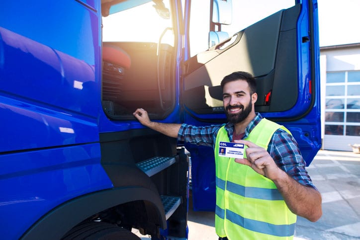 Man Next To Truck Holding CDL License
